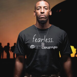 fearless ROCKcourage_black military_black shirt_a20926_2000x2000 Young black soldier standing with soldiers loading plan in background wearing ROCK Fashion brand t-shirt with statement fearless ROCK courage