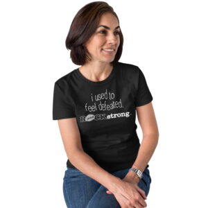 i-used-to-feel-defeated-ROCKstrong-woman-sitting-round-neck-black-tshirt-a15867_1500x1500 Women seated on stool with legs crossed wearing ROCK Fashion brand t-shirt with statement I used to feel defeated ROCKstrong